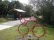 Scenic bike trail with cyclist and artistic bike structure, inviting for outdoor recreation at 4257 Hearthstone Dr, Sarasota, FL 34238