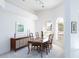 Formal dining room bathed in natural light with modern decor and classic furniture at 4257 Hearthstone Dr, Sarasota, FL 34238