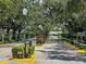 Gated community entrance with lush trees and maintained landscaping at 4257 Hearthstone Dr, Sarasota, FL 34238