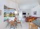 Open living area with large windows offering tranquil pool and lake views at 4257 Hearthstone Dr, Sarasota, FL 34238