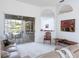 Bright living room with a view of the screened-in patio, lake, and outdoor seating at 4257 Hearthstone Dr, Sarasota, FL 34238