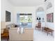 Open-concept living room with neutral tones and views of the lake at 4257 Hearthstone Dr, Sarasota, FL 34238