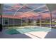 A screened-in pool with a view of the lake at 4257 Hearthstone Dr, Sarasota, FL 34238