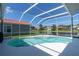 Screened-in pool area overlooking a serene lake and lush surroundings at 4257 Hearthstone Dr, Sarasota, FL 34238