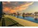 Waterfront homes boast serene water views and scenic surroundings under a golden sunset at 4257 Hearthstone Dr, Sarasota, FL 34238