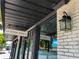 Exterior view of 'The Yoga Shack', featuring a brick wall, black awning, and prominent signage at 430 Kumquat Ct # 410, Sarasota, FL 34236