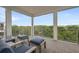 Relaxing outdoor balcony with seating, beautiful tree-top views, and refreshing breezes at 4321 Marina View Way, Cortez, FL 34215