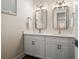 Bathroom featuring a double vanity with white cabinets, quartz countertops, and modern rectangular mirrors at 4321 Marina View Way, Cortez, FL 34215