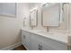 Modern bathroom with double sinks, quartz countertop, and elegant lighting at 4321 Marina View Way, Cortez, FL 34215
