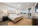 Bright bedroom with a ceiling fan, a balcony door, and a stylish decor at 4321 Marina View Way, Cortez, FL 34215
