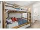 Charming bedroom with a wooden bunk bed, featuring nautical-themed bedding and decor at 4321 Marina View Way, Cortez, FL 34215