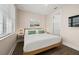 Bright bedroom featuring a bed with a white duvet, and wood-look flooring at 4321 Marina View Way, Cortez, FL 34215