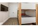 Bedroom featuring wooden bunk beds, wood-look floors and a modern TV at 4321 Marina View Way, Cortez, FL 34215