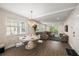 Elegant dining area with a modern chandelier, seating for six, and open living space at 4321 Marina View Way, Cortez, FL 34215