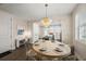 Elegant dining area with a modern chandelier, seating for six, and view of the kitchen at 4321 Marina View Way, Cortez, FL 34215