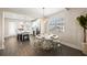 Elegant dining area with a modern chandelier, seating for six, and a glimpse of the kitchen at 4321 Marina View Way, Cortez, FL 34215