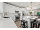Bright kitchen with stainless steel appliances, island with seating and gorgeous pendant lighting at 4321 Marina View Way, Cortez, FL 34215