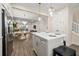 Open concept kitchen with a gray island, quartz countertop, and stainless steel refrigerator at 4321 Marina View Way, Cortez, FL 34215