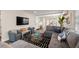 Stylish living room featuring a gray sectional sofa, patterned rug, and open floor plan at 4321 Marina View Way, Cortez, FL 34215