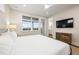 Bright and cozy bedroom with a large window, a ceiling fan, and a ensuite bathroom at 4321 Marina View Way, Cortez, FL 34215