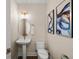 Elegant powder room featuring stylish fixtures and octopus artwork at 4321 Marina View Way, Cortez, FL 34215