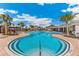 Expansive community pool with palm trees, lounge chairs, and clear blue water at 4404 Weathered Moss Gln, Palmetto, FL 34221