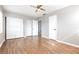 Bedroom with ceiling fan, wood floors, and closet doors at 4507 9Th W St # A2, Bradenton, FL 34207