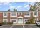 Brick two-story condominium building with a white door and white framed windows at 4507 9Th W St # A2, Bradenton, FL 34207