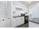 The cozy kitchen features white cabinets, stainless steel sink, and dark appliances at 4507 9Th W St # A2, Bradenton, FL 34207