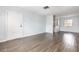 The open-concept living room has wood-look tile flooring, white trim, and natural light at 4507 9Th W St # A2, Bradenton, FL 34207