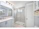 Elegant bathroom featuring a tiled shower, modern vanity, and ample storage at 5213 Bel Air Ave, Sarasota, FL 34234