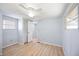 Comfortable bedroom with ceiling fan, natural light, and wood-look floors at 5213 Bel Air Ave, Sarasota, FL 34234
