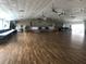 Large hall with hardwood floors, a stage, tables, chairs, and ceiling fans, perfect for events and gatherings at 5213 Bel Air Ave, Sarasota, FL 34234