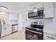Modern kitchen featuring stainless steel appliances, white cabinets, and a beautiful backsplash at 5213 Bel Air Ave, Sarasota, FL 34234