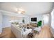 Comfortable living room with plenty of seating, natural light, and hardwood flooring at 5213 Bel Air Ave, Sarasota, FL 34234