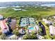 Stunning aerial view showcasing tennis courts, a pool, ponds, and lush green surroundings at 5450 Eagles Point Cir # 404, Sarasota, FL 34231