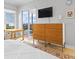 Bedroom features a dresser, TV, access to the outside, and views of the lake at 5450 Eagles Point Cir # 404, Sarasota, FL 34231