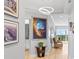 Bright hallway with artwork leading to balcony with great views and natural light at 5450 Eagles Point Cir # 404, Sarasota, FL 34231
