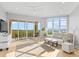 Bright and airy living room with access to a private balcony and scenic views at 5450 Eagles Point Cir # 404, Sarasota, FL 34231