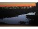 Picturesque night view featuring the city skyline reflecting on the calm waterfront at 5450 Eagles Point Cir # 404, Sarasota, FL 34231
