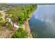 Scenic lakefront view with a pathway, trees, and a glimpse of kayaks highlighting the community's recreational amenities at 5532 Summit Gln, Bradenton, FL 34203