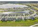 Aerial shot showcases a house with a pool, nestled in a lakeside community with lush green lawns at 5532 Summit Gln, Bradenton, FL 34203