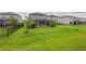 Expansive backyard with lush green grass, iron fence, and manicured landscaping at 5532 Summit Gln, Bradenton, FL 34203