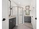 Bright bathroom featuring double vanities, granite countertops, and a glass-enclosed shower at 5532 Summit Gln, Bradenton, FL 34203