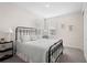 Bright bedroom featuring a black metal bed frame, soft carpet, and natural light from the windows at 5532 Summit Gln, Bradenton, FL 34203