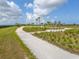 Scenic walking path featuring grassy areas, workout equipment, and views of the surrounding landscape at 5532 Summit Gln, Bradenton, FL 34203