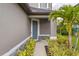 Home exterior featuring a blue front door, stone accents, and landscaped entry at 5532 Summit Gln, Bradenton, FL 34203