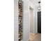 Stylish hallway showcasing a wine rack, shiplap accents and a sophisticated lighting fixture at 5532 Summit Gln, Bradenton, FL 34203