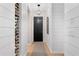 Elegant hallway featuring a wine rack and a black front door, creating a sophisticated entrance at 5532 Summit Gln, Bradenton, FL 34203