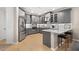 Modern kitchen featuring gray cabinetry, stainless steel appliances, white countertops and an eat-in breakfast bar at 5532 Summit Gln, Bradenton, FL 34203
